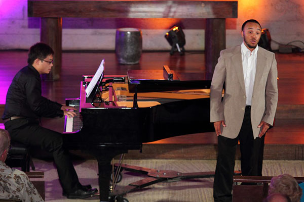 piano player and male singer on stage