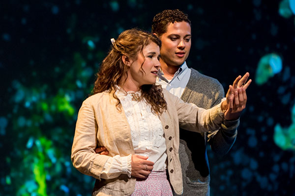 woman and man performing on stage